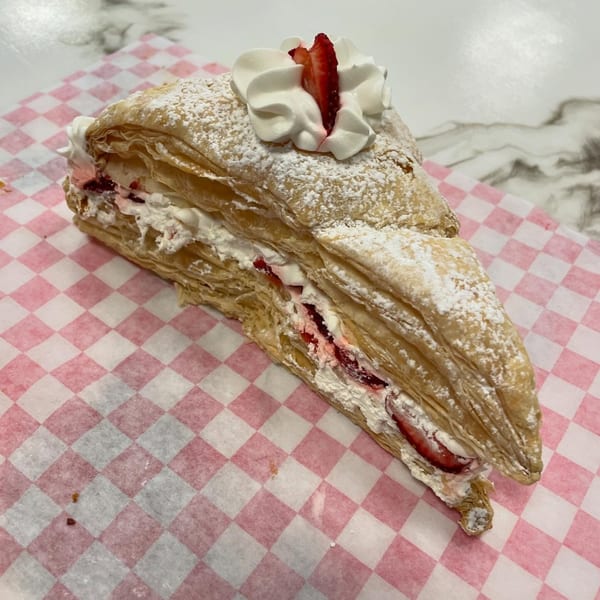 Sweet Antojito's strawberry Napoleon pastry, dusted with powdered sugar and topped with whipped cream.