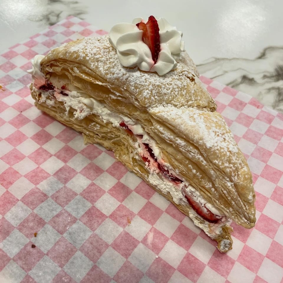 Sweet Antojito's strawberry Napoleon pastry, dusted with powdered sugar and topped with whipped cream.