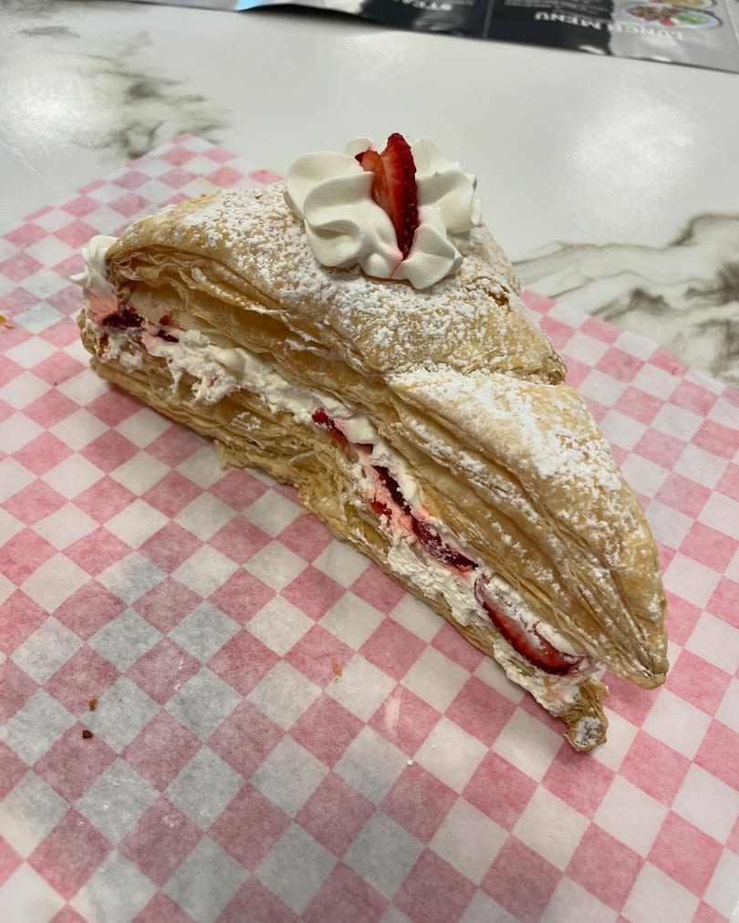 Sweet Antojito's strawberry Napoleon pastry, dusted with powdered sugar and topped with whipped cream.